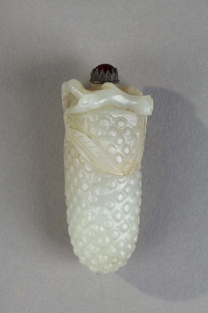 Nephrite jade snuffbottle carved in the shape of fruit branch in high relief and leaves around the opening of the bottle   - China 19th century
